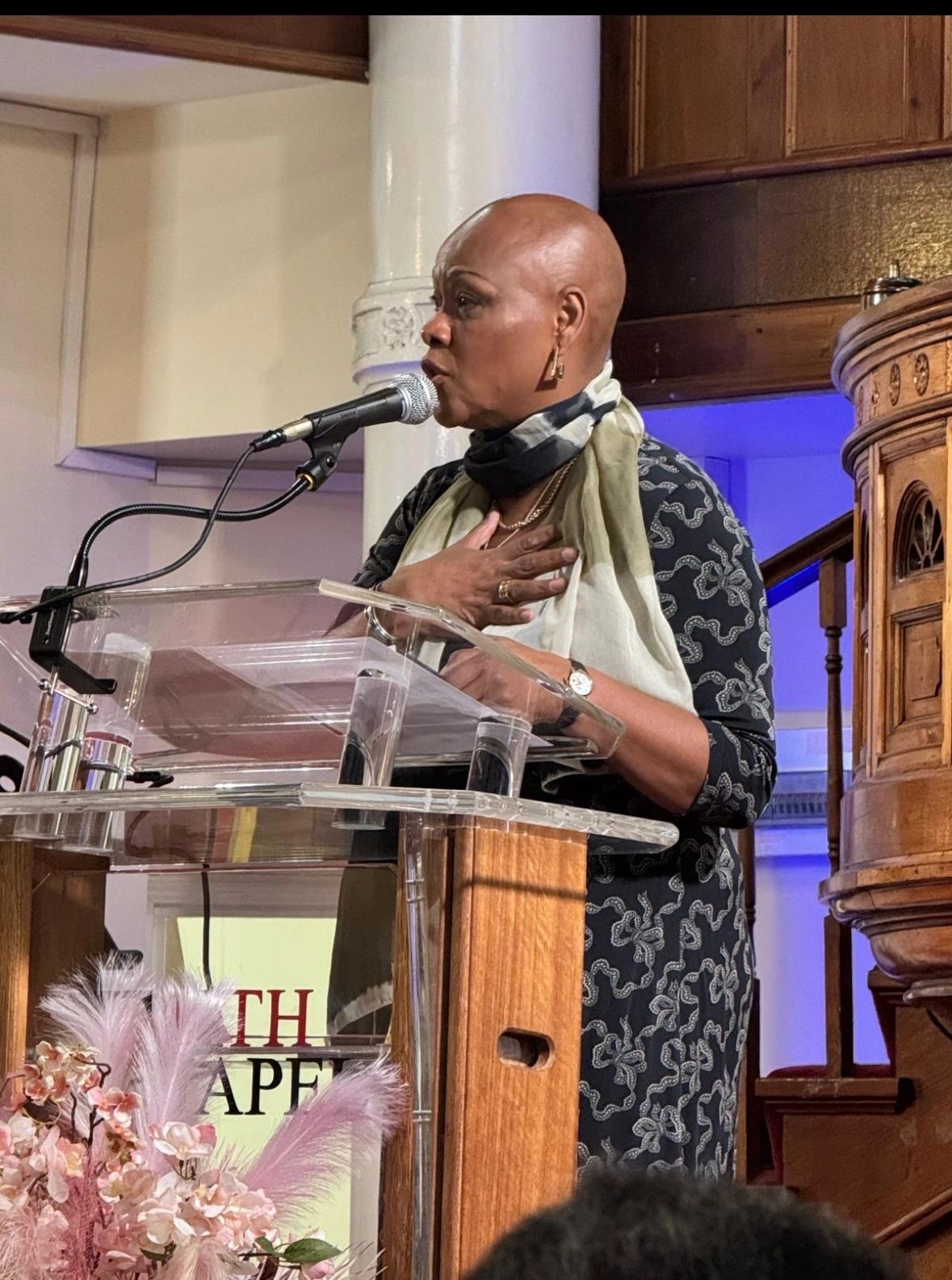 Sharon-Ann speaking passionately at a podium